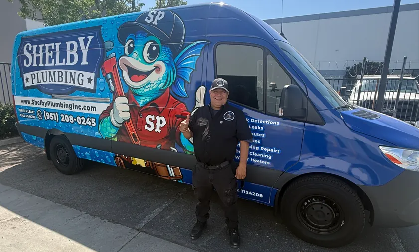 A Shelby Plumbing technician beside the company van